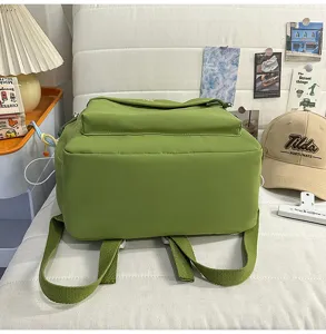 Detailed view of green campus style backpack, showing large capacity and durable shoulder straps.