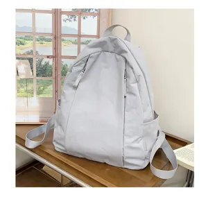 Korean style solid color casual backpack lightweight travel school bag for daily use.