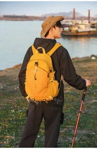 Outdoor large capacity hiking backpack in yellow and black, featuring multi-pockets and straps.