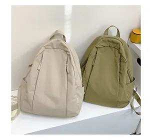 Casual minimalist solid color backpack detail shot, lightweight everyday travel bookbag.