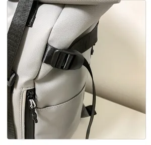 Grey backpack detail view showing adjustable strap buckle and durable zipper pocket design.