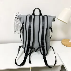 Grey casual roll-top backpack large capacity school bag for men and women daily travel use.