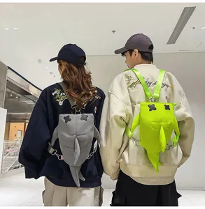 Detailed shot of cute couple shark backpacks with 3D fins and cross eyes, trendy streetwear style.