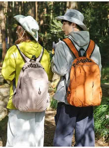 Outdoor travel scene featuring lightweight waterproof unisex backpack in natural forest.