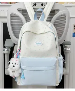Japanese sweet style student backpack detail view, white blue star pattern with cute puppy pendant.