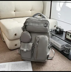 Gray multi-pocket casual backpack with cute round pouch, spacious daily school travel bag.