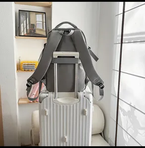 Grey travel backpack with luggage strap, large capacity unisex computer book bag for daily use.