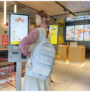 Sac à dos style écolier doux japonais avec motif étoile, design multi-poches pour étudiants.