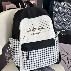 Canvas polka dot backpack with plaid front pocket, stylish school bag for daily commute and teens.