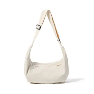 Detail shot of casual white nylon crossbody shoulder bag, lightweight commuter travel bag.