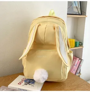 Cute Japanese style yellow canvas backpack for women students with long bunny ears and tail.
