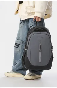 Detail view of the black and grey casual backpack, showing front zipper pocket and strap design.