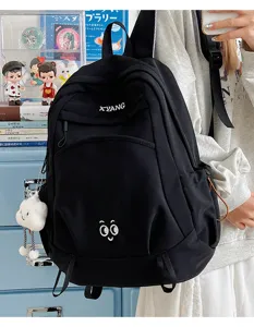 Large capacity black canvas backpack simple casual school bag for women students travel daily.