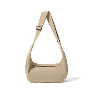 Large capacity canvas crossbody bag detail showing durable adjustable strap and smooth zipper.