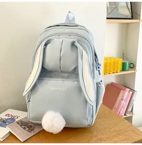 Cute light blue bunny ear backpack detail view with fluffy tail, Harajuku style school bag.