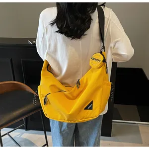 Casual nylon canvas crossbody bag for men and women, stylish commuter messenger shoulder bag.