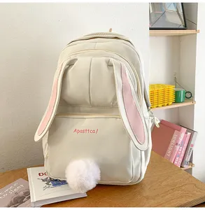 Cute bunny ears canvas backpack detail showing fluffy tail and front pocket with stylish letters.