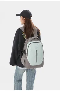 Detailed view of the stylish two-tone casual backpack worn by model, showing vertical zipper pocket.