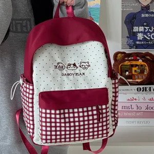 Cute Japanese style college backpack for women with red and white plaid and polka dot patterns.