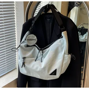 Casual crossbody bag for men and women, stylish commuter messenger bag with small round pouch.