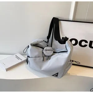 Casual tactical crossbody bag for men and women, stylish commuter shoulder bag in gray color.