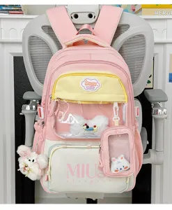 Pink cute student schoolbag with transparent pocket and plush pendant for daily casual wear.