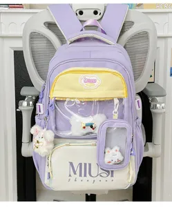 Japanese style sweet purple backpack with transparent front pocket and cute plush doll pendants.