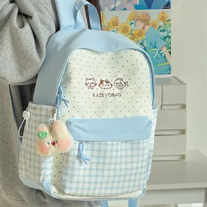 Japanese style sweet polka dot plaid school backpack with cute plush pendant for daily student use.