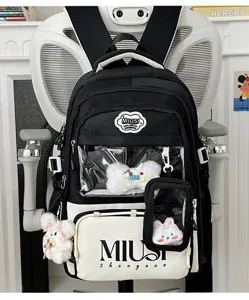 Detail of Japanese style student backpack featuring clear front pocket and cute plush pendants.
