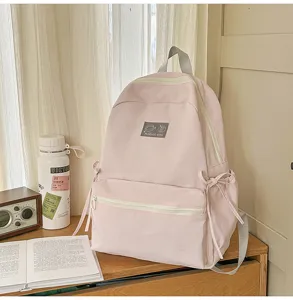 Minimalistische roze rugzak met grote capaciteit voor studenten en dagelijks gebruik.