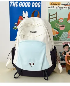 Detailed view of the color-blocked canvas backpack with cute front embroidery and side pockets.