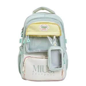 Detailed view of the mint green student backpack with clear pocket and cute pendant charm.