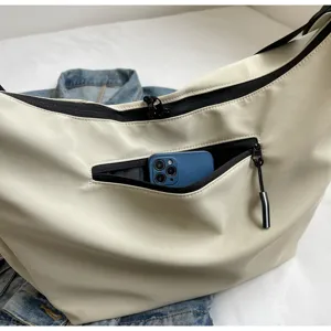 Casual streetwear shoulder bag detail, spacious crossbody design, everyday commuter style.
