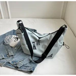 Detail view of the casual commuting crossbody messenger bag with durable wide strap and pockets.