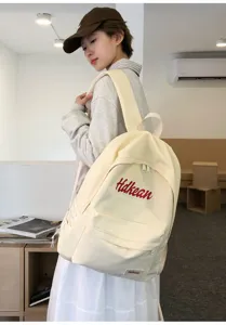 Casual canvas backpack for women, stylish student commuter bag with large capacity design.