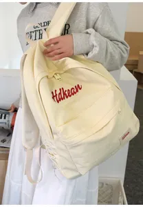 Casual canvas backpack for women, lightweight commuter school bookbag with cute side drawstring details.