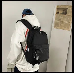 Minimalist black backpack for men and women, large capacity computer bag for daily use.