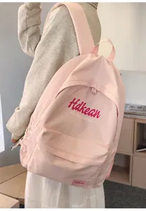 Pink college style backpack detail with minimalist design and front pocket for commute.