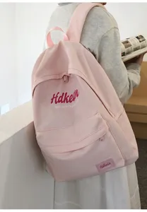 Pink canvas college style backpack, casual student commuting bookbag with front zipper pocket.
