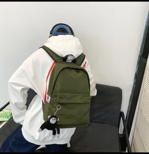 Casual large capacity green canvas laptop backpack with cute monkey pendant for daily school use.
