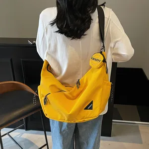 Casual canvas messenger bag for men and women, stylish yellow crossbody bag with pouch.