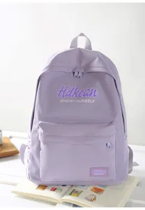 Detail view of the light purple backpack front pocket and zipper design for everyday school use.