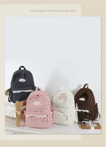 Detailed view of sweet Japanese style polka dot backpacks with lace and cute cloud embroidery.