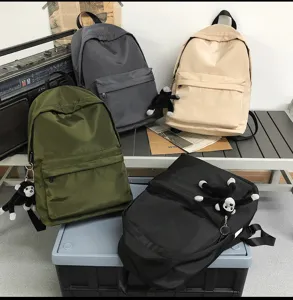 Casual nylon school backpack with cute monkey pendant, large capacity daily computer bag for students.