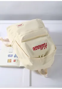 Detail view of minimalist beige backpack, casual college style schoolbag for daily commute