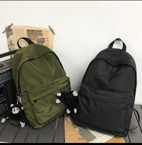 Casual nylon backpack for students, large capacity bookbag with cute monkey pendant.