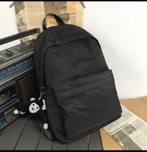 Minimalist black casual backpack for daily school and college students, large capacity design.