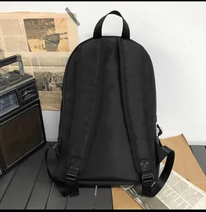 Minimalist black backpack for casual daily use, comfortable straps, sleek solid design.