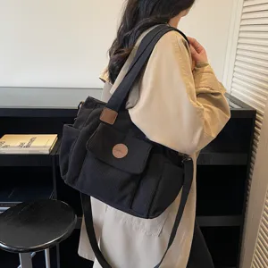Casual black corduroy tote shoulder bag for women, versatile commuting crossbody bag.