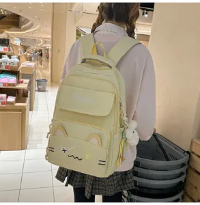 Cute cat backpack detail view featuring embroidered design and yellow canvas school backpack style.